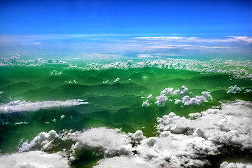 Image showing High in the sky, puffy white clouds