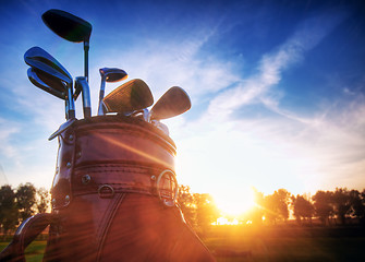 Image showing Golf gear, clubs at sunset