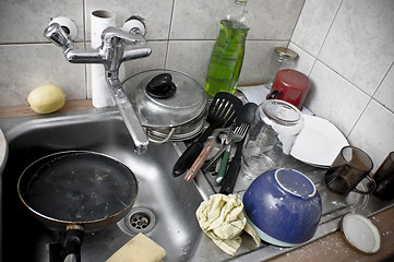 Image showing Pile of dirty dishes in the metal sink