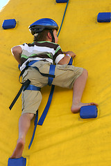 Image showing Child climbing a climbing wall