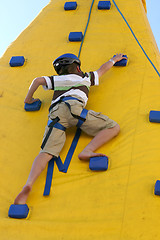 Image showing Boy climbing a climbing wall.