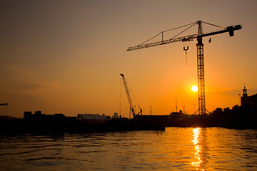 Image showing Industrial harbor at sunset and a crane