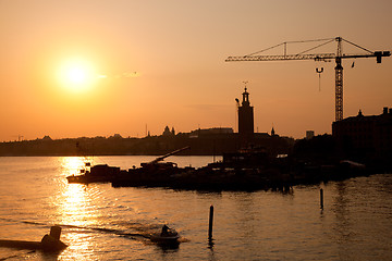 Image showing Industrial harbor at sunset and a crane