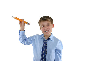 Image showing Smiling schoolboy holding a pencil