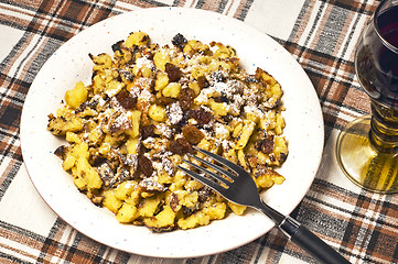 Image showing  cut-up and sugared pancake with raisins