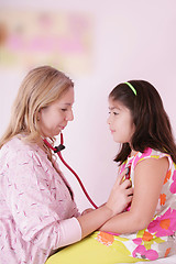 Image showing Female doctor examining little girl 
