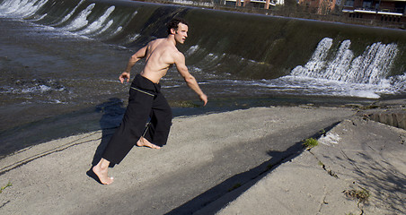 Image showing Shirtless man walking.