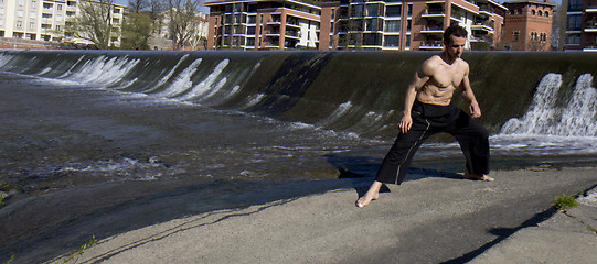 Image showing Well shaped man exercising outdoors.