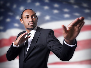 Image showing young African American guy and a flag