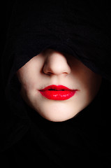 Image showing Closeup photo of a woman in black hood and red lips