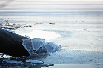 Image showing Sewer pipe frozen into water at winter