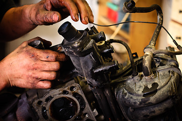 Image showing Worker repairing mechanical component