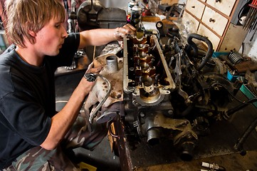 Image showing Mechanic worker inspecting car interiors