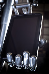 Image showing Robot hand holding tablet pc