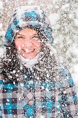 Image showing Out of focus picture of a woman with a lot of snowflakes