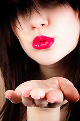 Image showing Beautiful young girl throwing a kiss at you