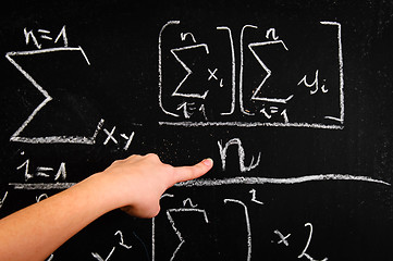 Image showing Hand of a girl pointing at chalkboard