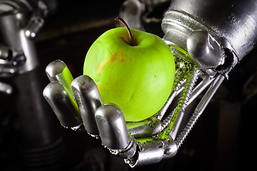 Image showing A robot hand holding a fresh apple