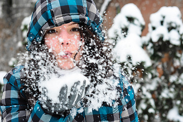 Image showing Attractive young woman with snow in her hand