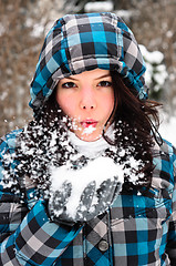 Image showing Attractive young woman with snow in her hand