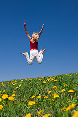 Image showing young woman in red outfit having fun on meadow