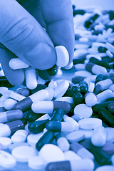 Image showing hand grabbing pills