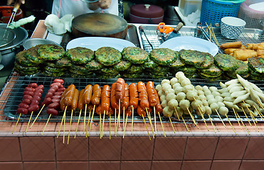 Image showing Asian street food tray with skewers