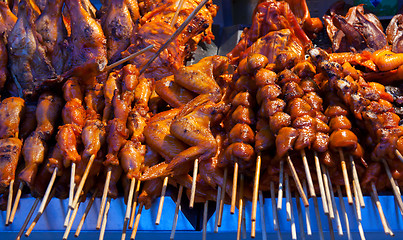Image showing grilled skewers of meat and wings