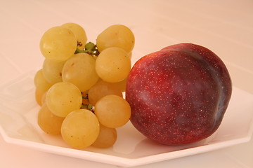 Image showing Grapes and plum on small plate