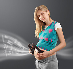 Image showing pregnant female with headphones