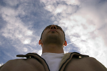 Image showing Man Looking up with the Clouds on the Background