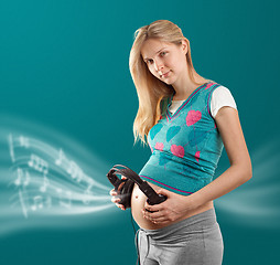 Image showing pregnant female with headphones