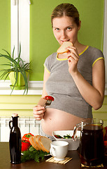 Image showing pregnant woman on kitchen