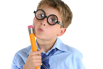 Image showing Comical boy holding a pencil and thinking