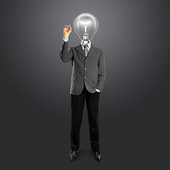 Image showing lamp head businessman writing something