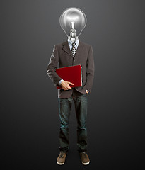 Image showing male in suit with lamp and laptop in his hands