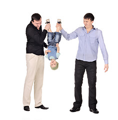 Image showing Two gusd holding little boy upside down