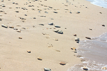 Image showing Footprints at the beach among the stones