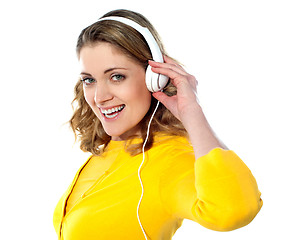 Image showing Beautiful young woman with headphones listening music