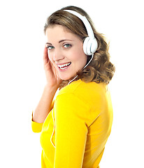 Image showing Attractive teenager tuned into music