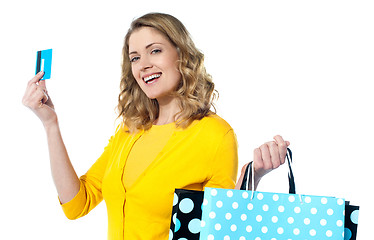 Image showing Attractive woman holding cerdit-card with shopping bags