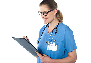 Image showing Female doctor holding a clipboard