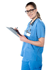 Image showing Female doctor holding a clipboard