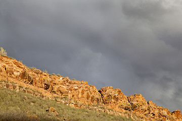 Image showing stormy sky over sandstone cliff