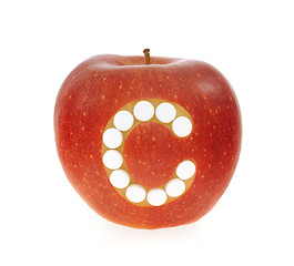 Image showing Red apple with vitamin c pills over white background - concept