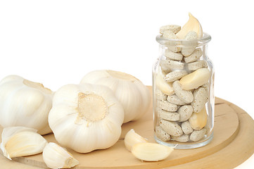 Image showing Garlic and herbal supplement pills isolated, alternative medicine concept