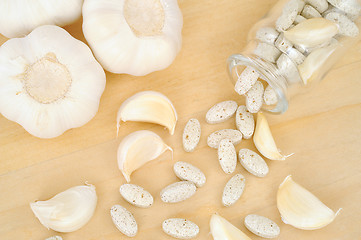 Image showing Garlic and herbal supplement pills, alternative medicine concept