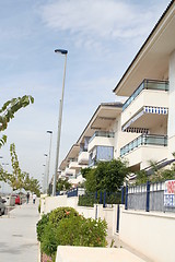 Image showing Apartment-buildings along a street next to the sea