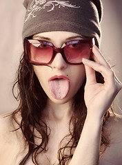 Image showing Girl shows her tongue