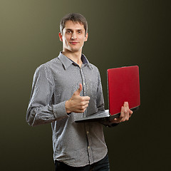 Image showing male with laptop in his hands well done